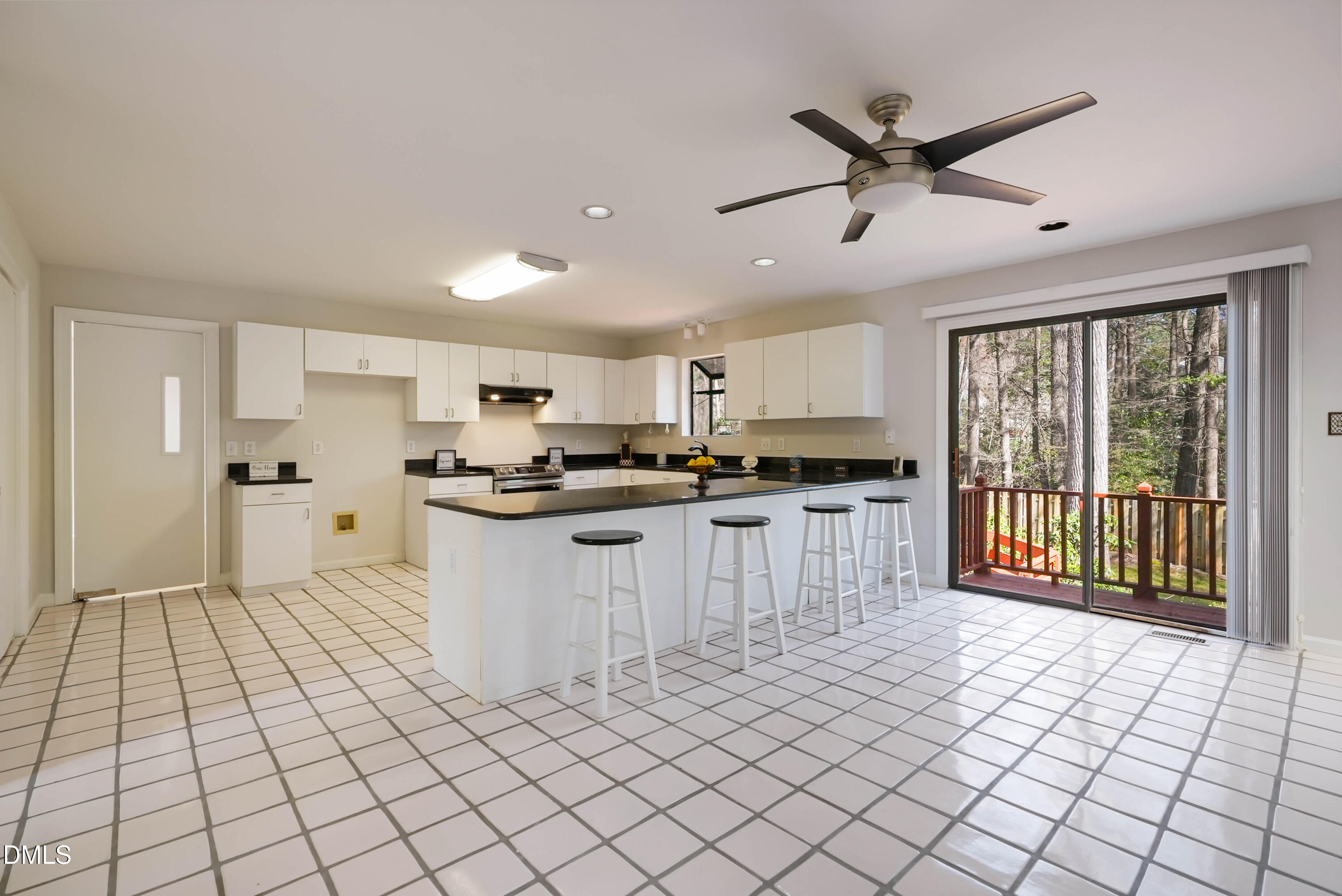 1500 Surfbird Court Raleigh, NC 27615 - Photo 18 of 47 a large white kitchen with cabinets a sink a window and stainless steel appliances