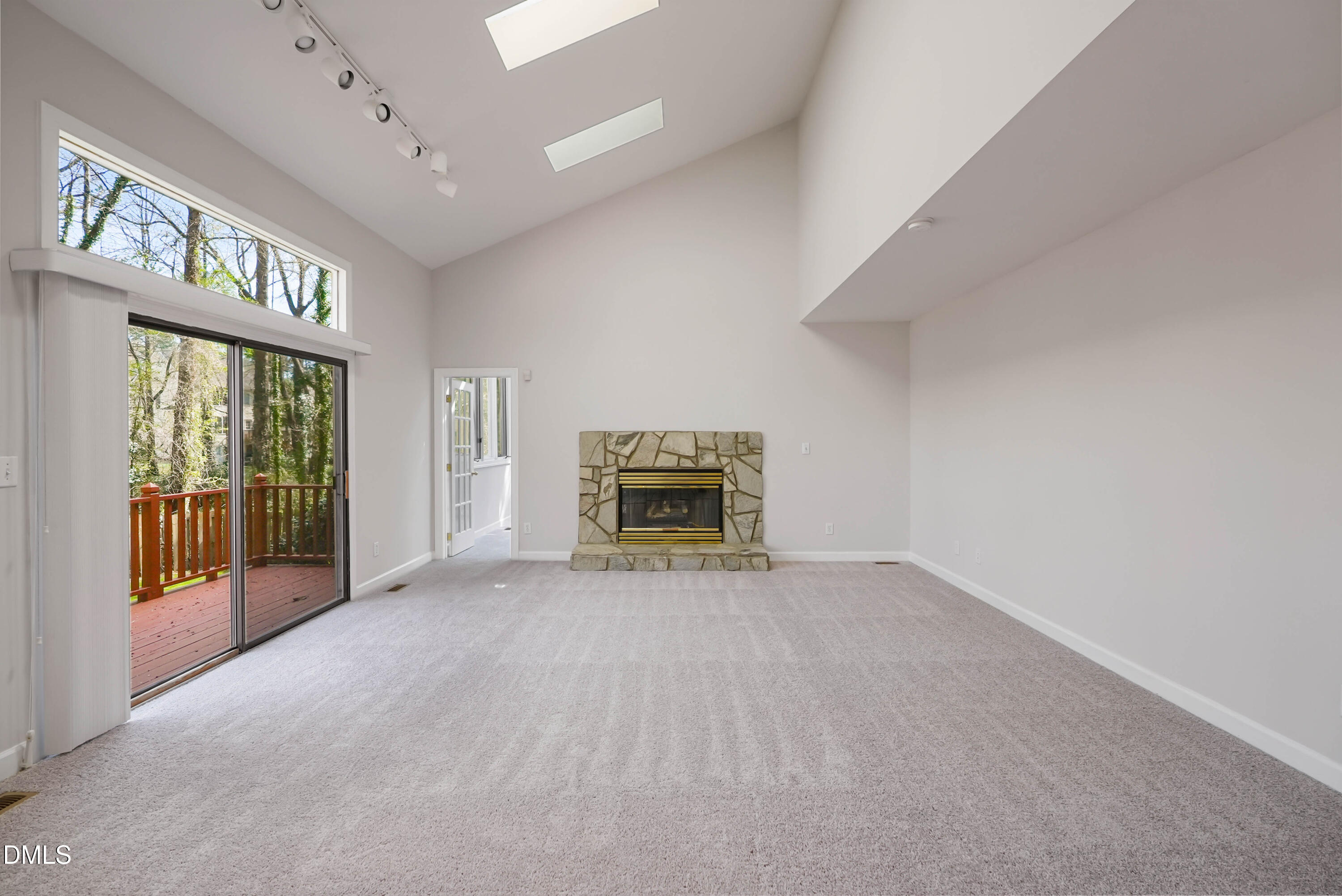 1500 Surfbird Court Raleigh, NC 27615 - Photo 20 of 47 a view of an empty room with a fireplace and a large window