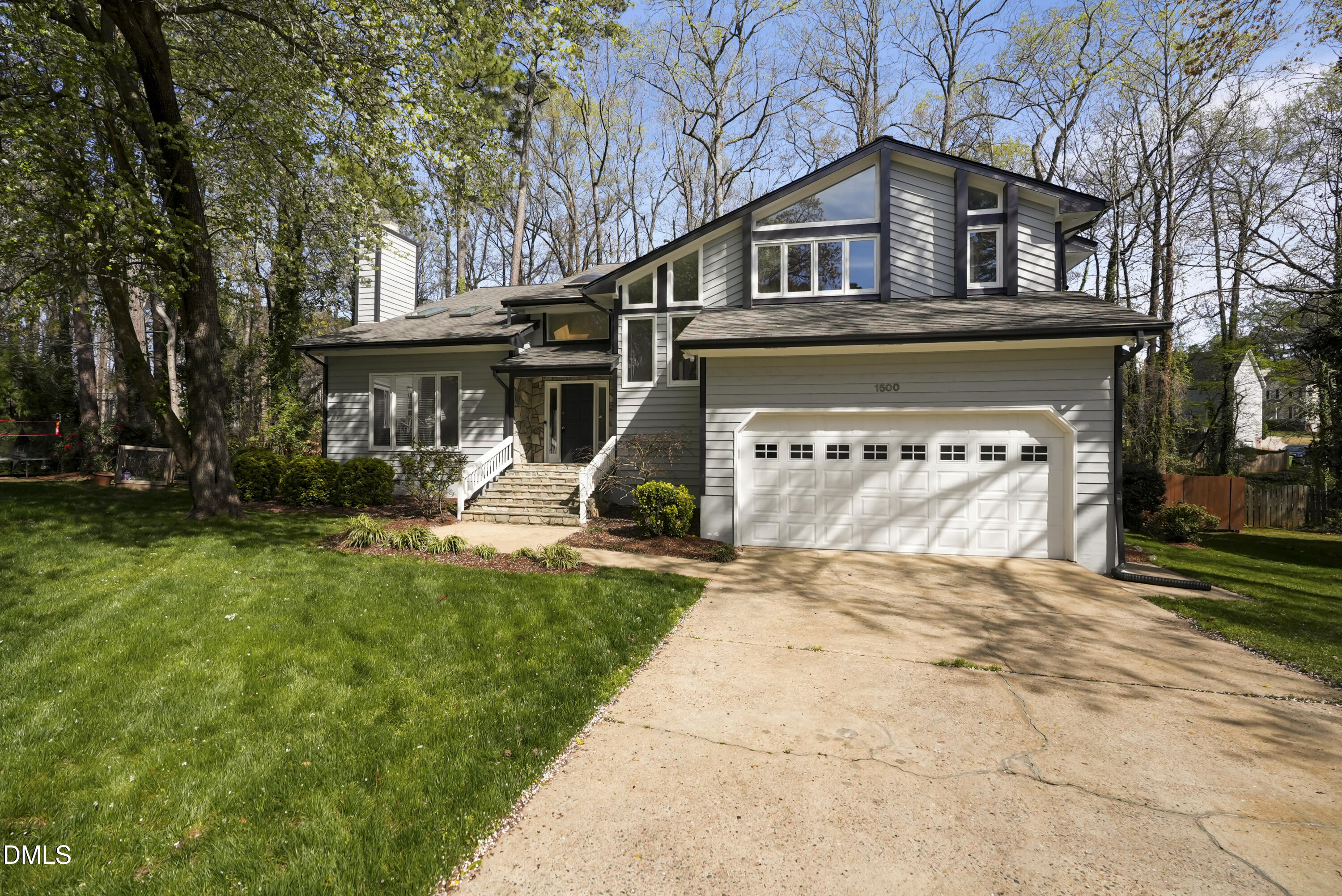 1500 Surfbird Court Raleigh, NC 27615 - Photo 4 of 47 a front view of a house with a garden and trees