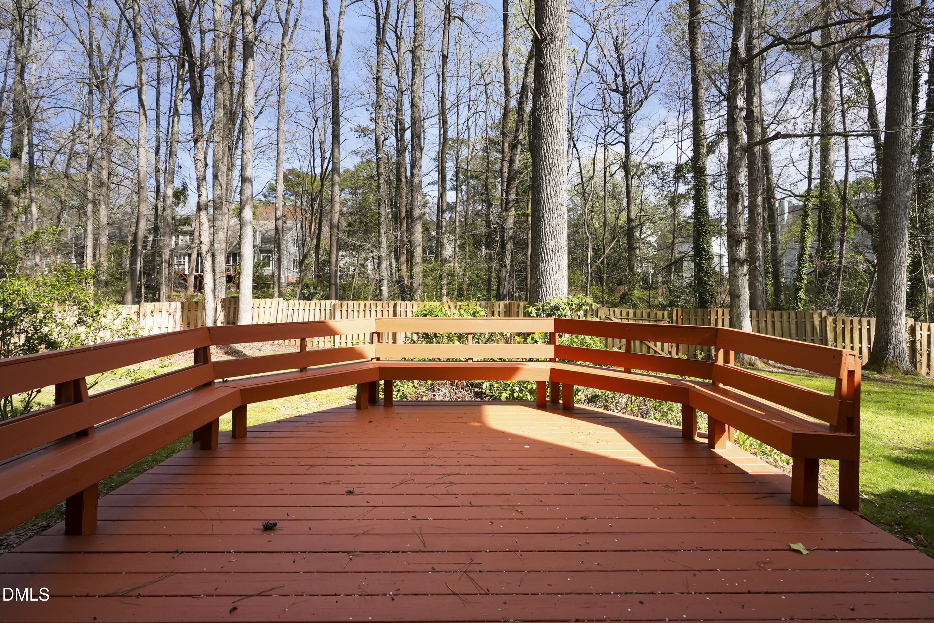 1500 Surfbird Court Raleigh, NC 27615 - Photo 44 of 47 a sitting area with wooden benches and trees in the background