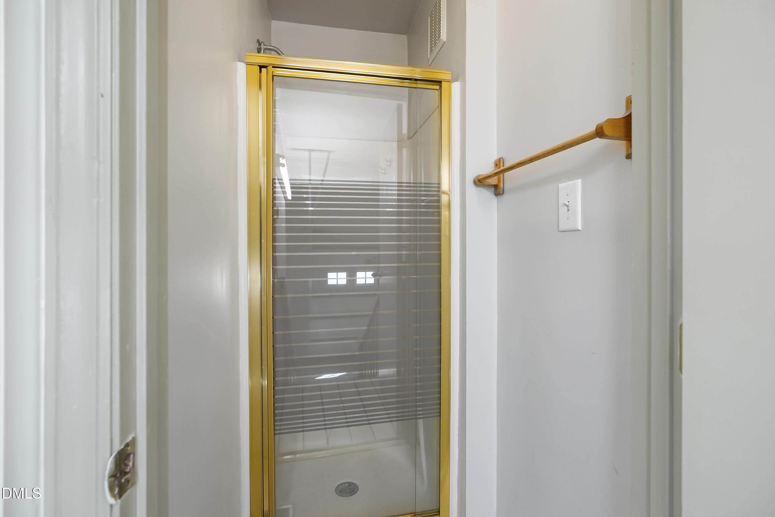 1500 Surfbird Court Raleigh, NC 27615 - Photo 47 of 47 a bathroom with a shower and a mirror