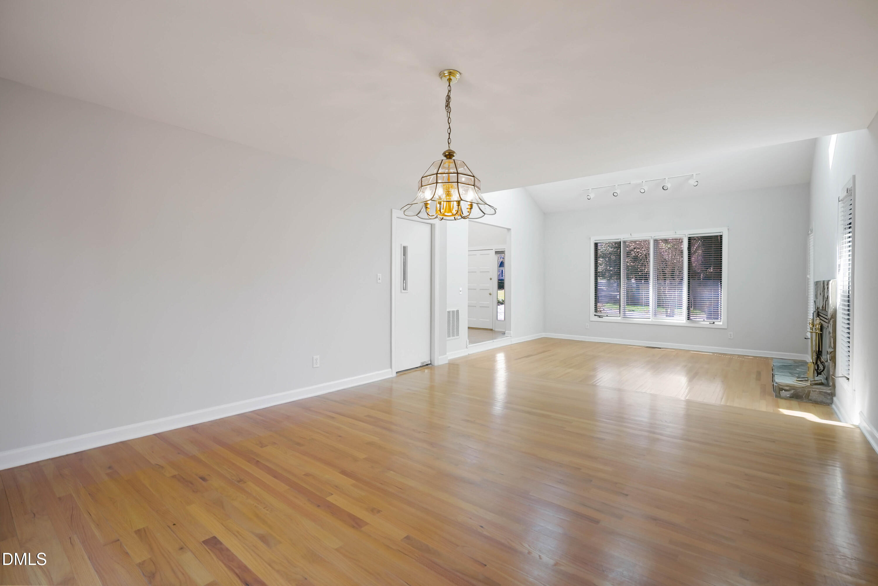 1500 Surfbird Court Raleigh, NC 27615 - Photo 10 of 47 a view of an empty room with window and wooden floor