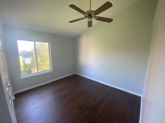 209 North Southport Road Mundelein, IL 60060 - Photo 14 of 18 an empty room with wooden floor fan and windows