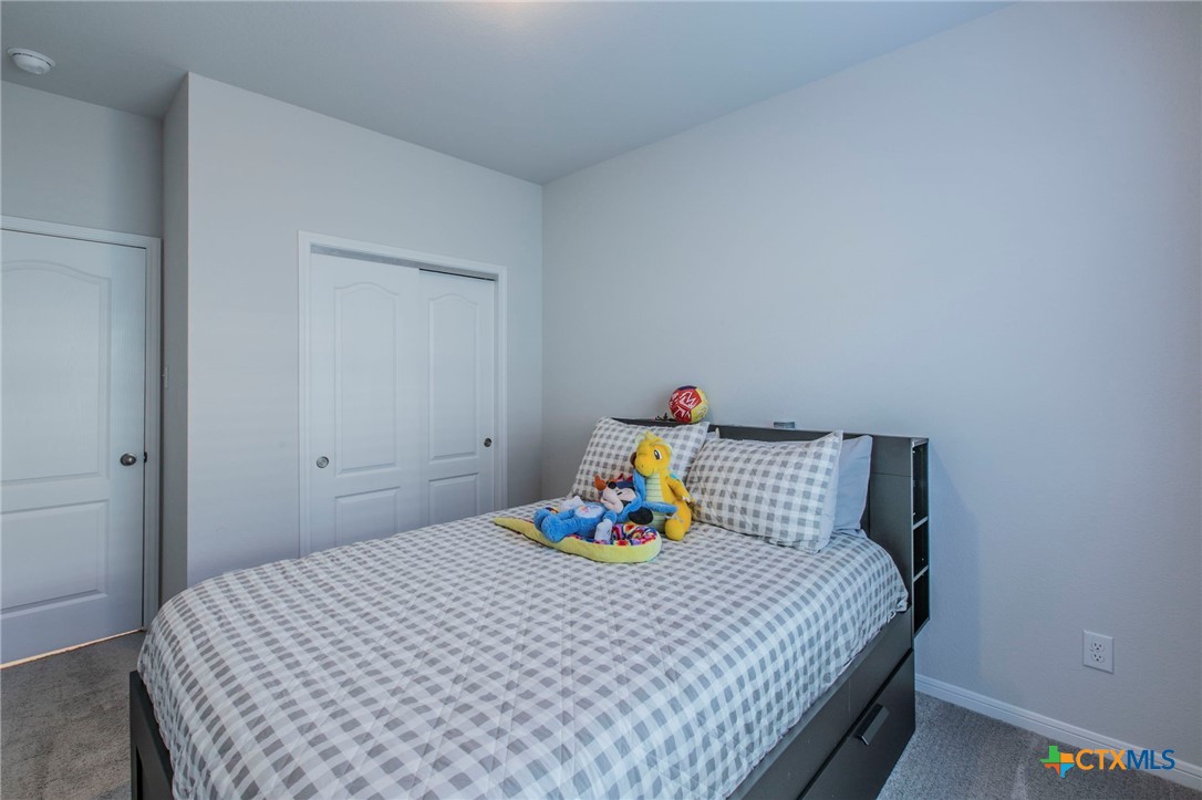 908 Coriander Road Temple, TX 76501 - Photo 17 of 28 a bedroom with a bed and a table