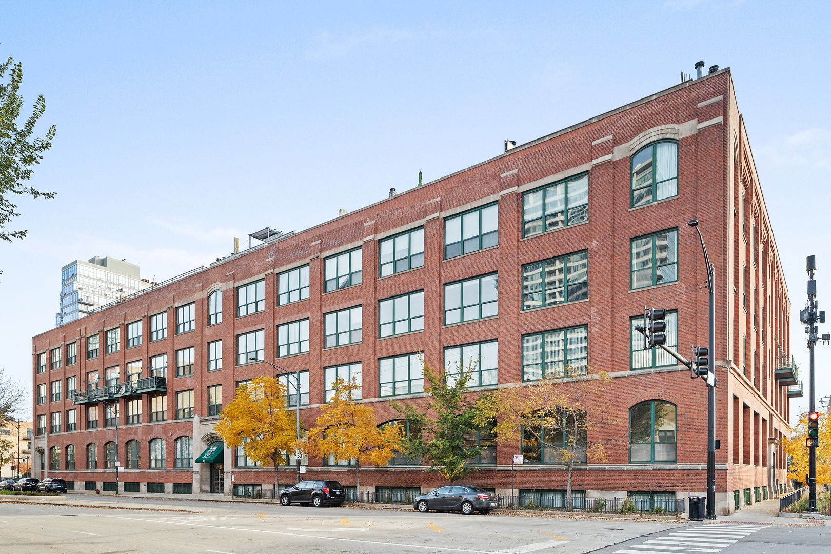 1727 South Indiana Avenue, Unit 319 Chicago, IL 60616 - Photo 1 of 21 a front view of a building with lot of cars and trees