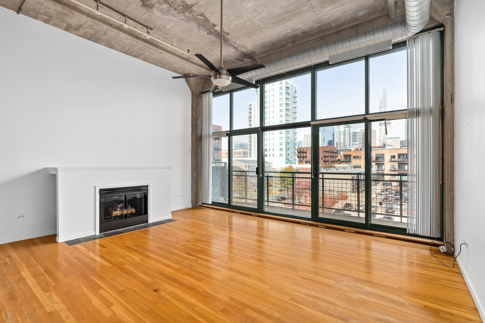 1727 South Indiana Avenue, Unit 319 Chicago, IL 60616 - Photo 12 of 21 a view of an empty room with wooden floor and a window