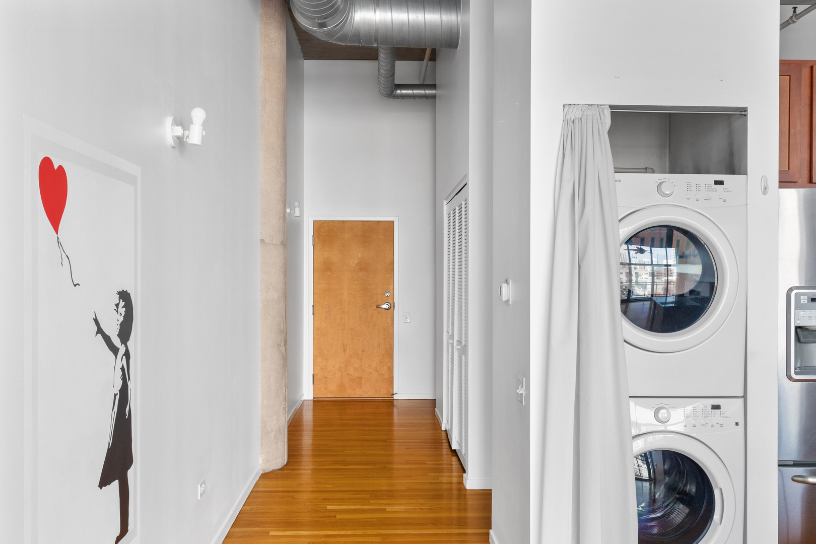 1727 South Indiana Avenue, Unit 319 Chicago, IL 60616 - Photo 6 of 21 a view of a hallway with washer and dryer
