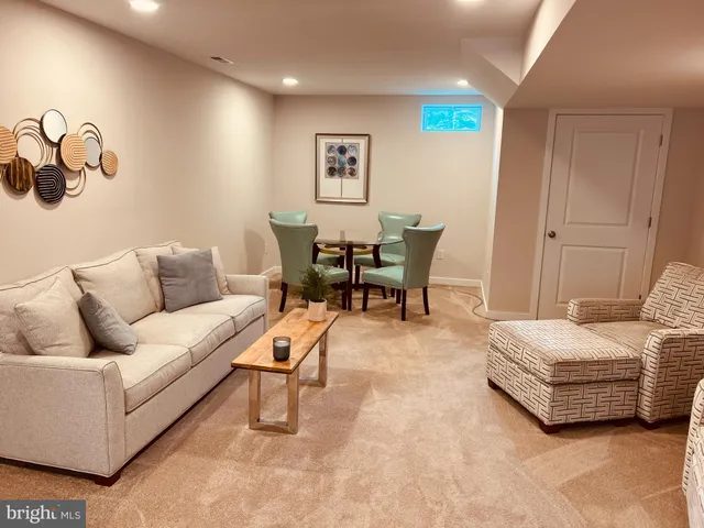 a living room with furniture and a chair