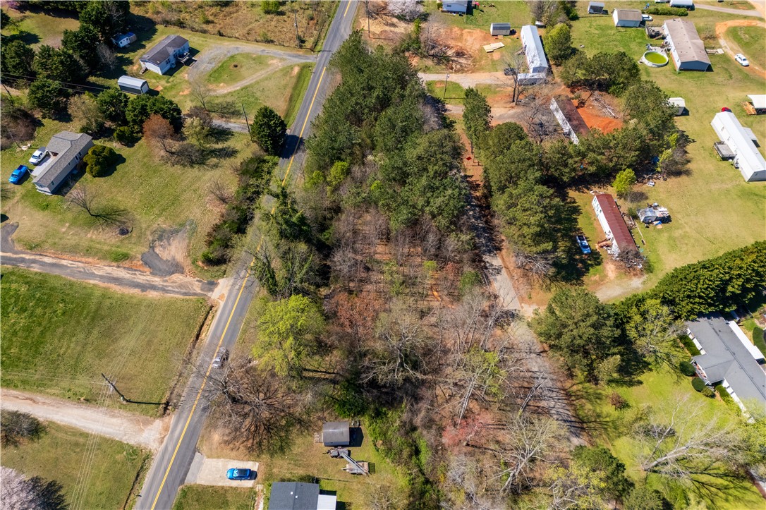 108 Watts Road Liberty, SC 29657 - Photo 2 of 3 An aerial view showcases a verdant lot surrounded by roads, offering serene rural living.