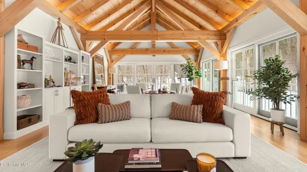 a living room with fireplace furniture and a large window