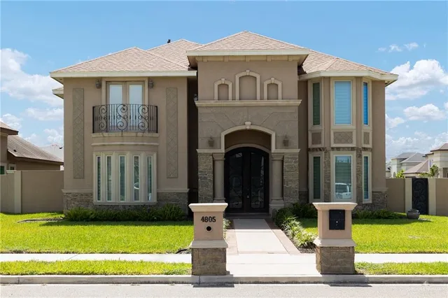 a front view of a house with a garden and plants