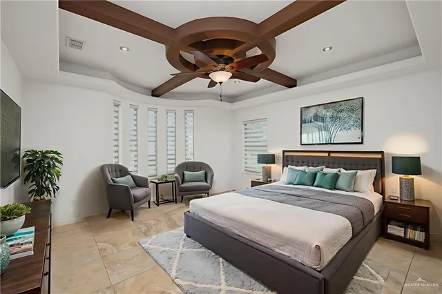 a spacious bedroom with a bed and a couch