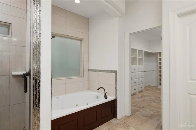 a bathroom with a tub sink and mirror