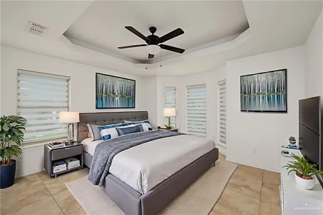 a bedroom with a bed table and a window