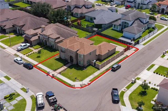 an aerial view of a house with a swimming pool and outdoor seating