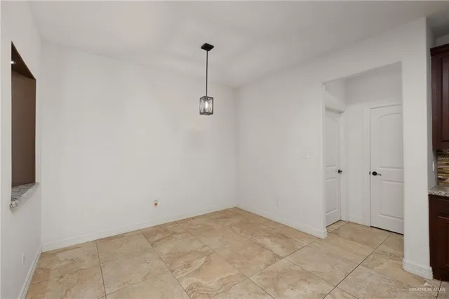 a view of an empty room with a fan