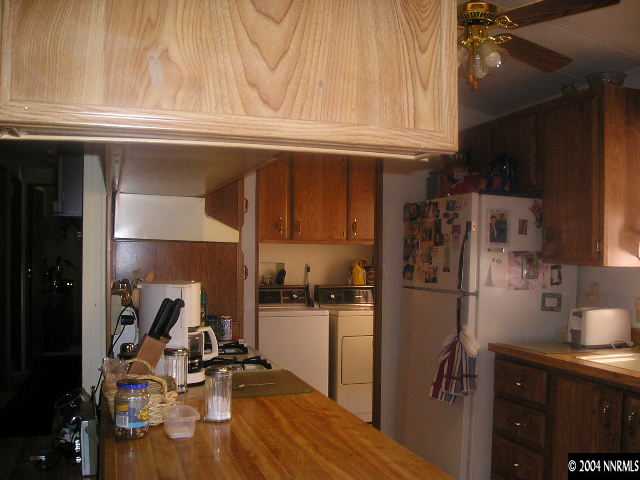 17325 Sunbird Lane Reno, NV 89508 - Photo 4 of 6 a kitchen with a refrigerator and a sink