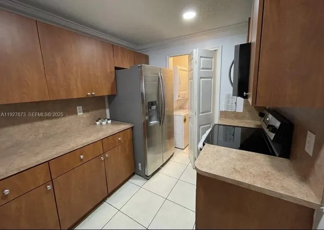 a kitchen with a refrigerator and a sink