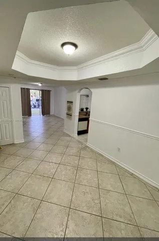 a view of a livingroom with wooden cabinets