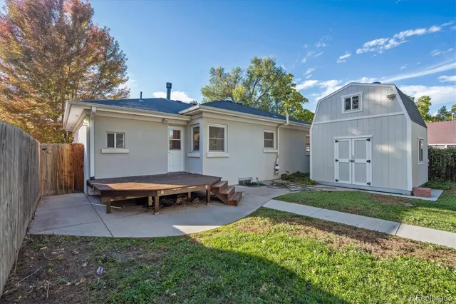 a backyard of a house with yard and outdoor seating