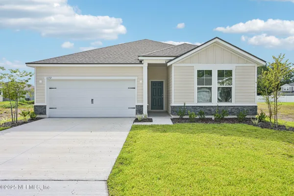 a view of a house with a yard and pathway