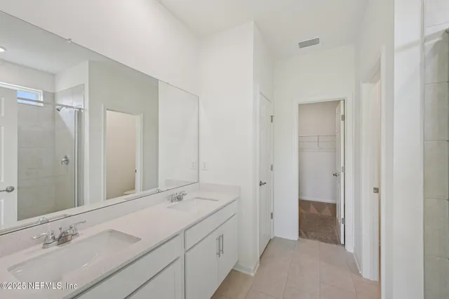 a bathroom with a double vanity sink and a mirror