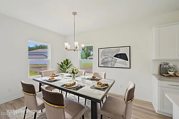 a view of a dining room furniture and wooden floor