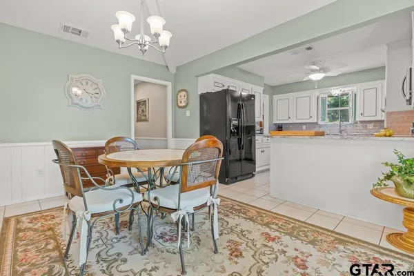 a dining room with furniture a rug and a chandelier