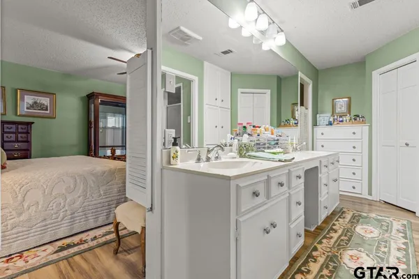 a spacious bathroom with a sink double vanity and a mirror