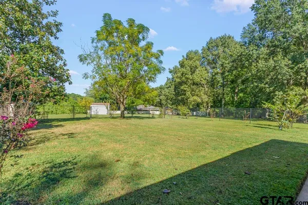 a view of a house with backyard and a garden