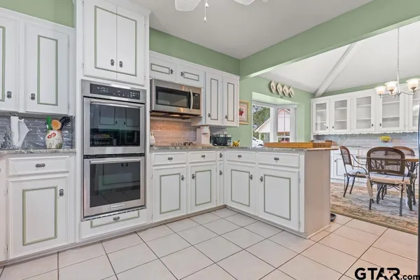 a kitchen with cabinets appliances and a sink