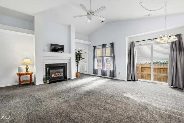 a view of a livingroom with a fireplace and a window
