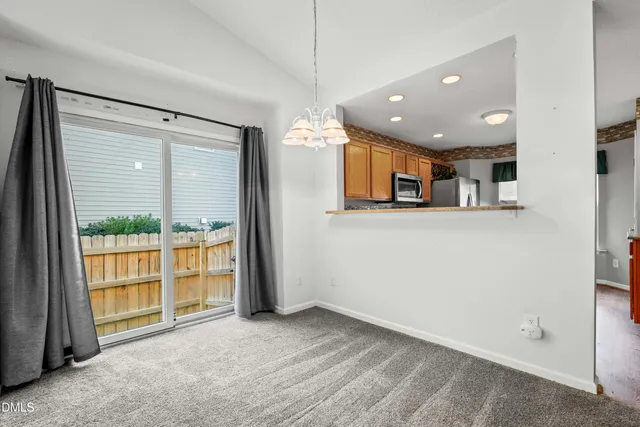 a view of a kitchen with furniture and a large window