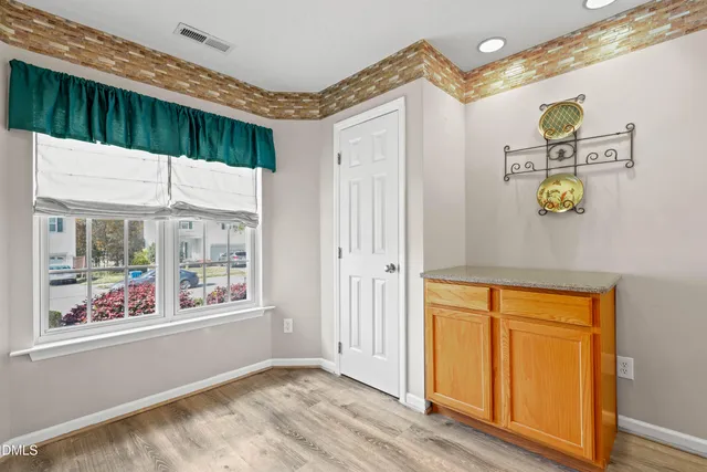 a view of an entryway with wooden floor