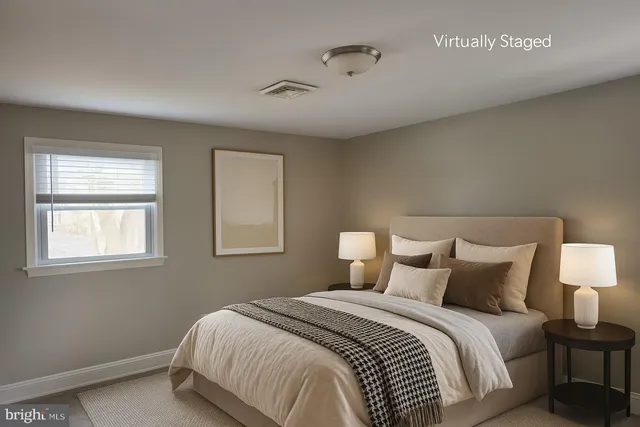 a bedroom with a bed and a night stand