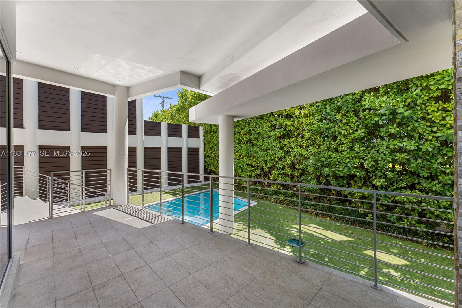 544 Fernwood Road, Unit 544 Key Biscayne, FL 33149 - Photo 14 of 35 a view of a balcony with floor to ceiling window next to a yard
