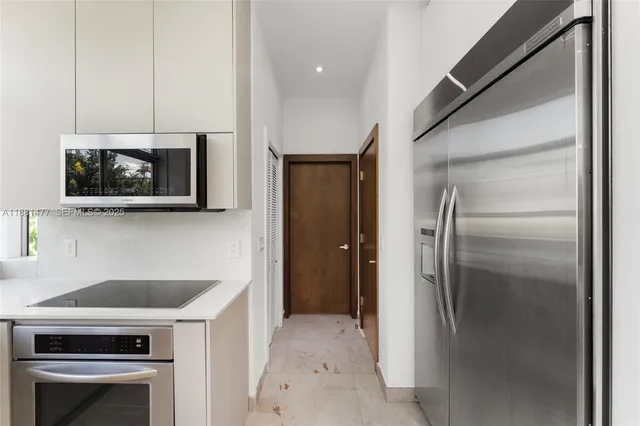 a kitchen with a refrigerator stove and microwave