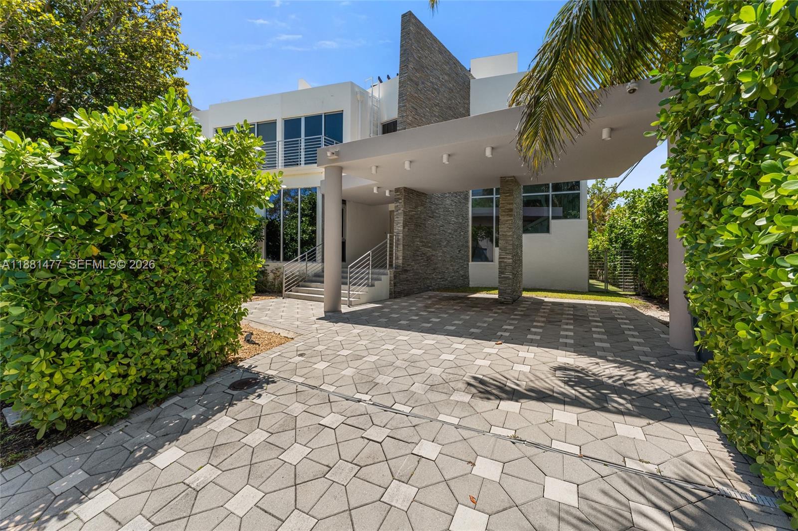 544 Fernwood Road, Unit 544 Key Biscayne, FL 33149 - Photo 17 of 35 a front view of a house with a yard
