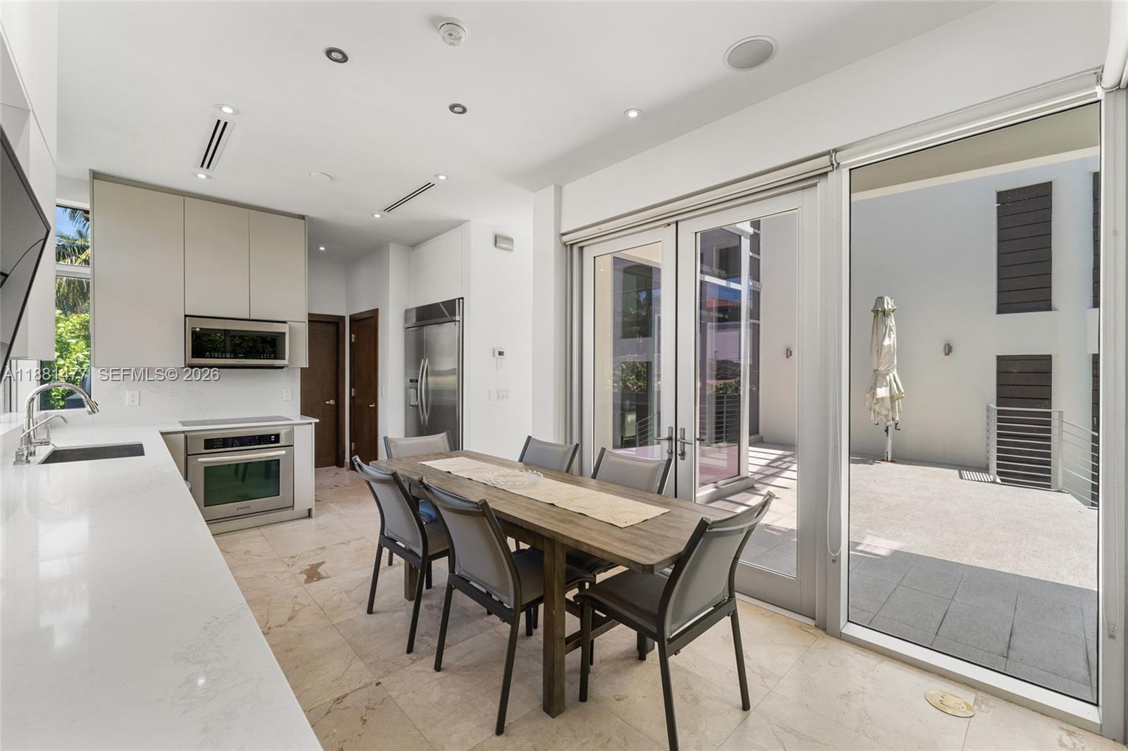 544 Fernwood Road, Unit 544 Key Biscayne, FL 33149 - Photo 19 of 35 a view of a dining room with furniture and a kitchen