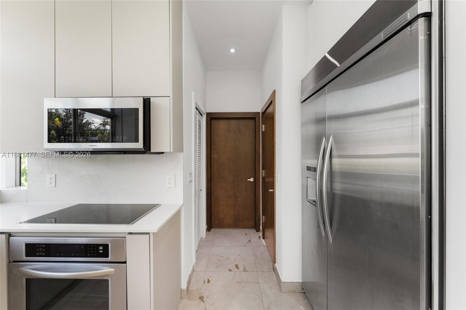 544 Fernwood Road, Unit 544 Key Biscayne, FL 33149 - Photo 22 of 35 a kitchen with a refrigerator stove and microwave