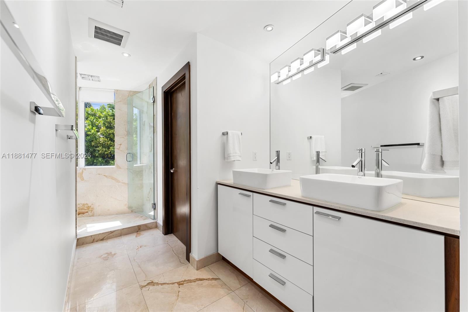 544 Fernwood Road, Unit 544 Key Biscayne, FL 33149 - Photo 26 of 35 a bathroom with a double vanity sink and a mirror
