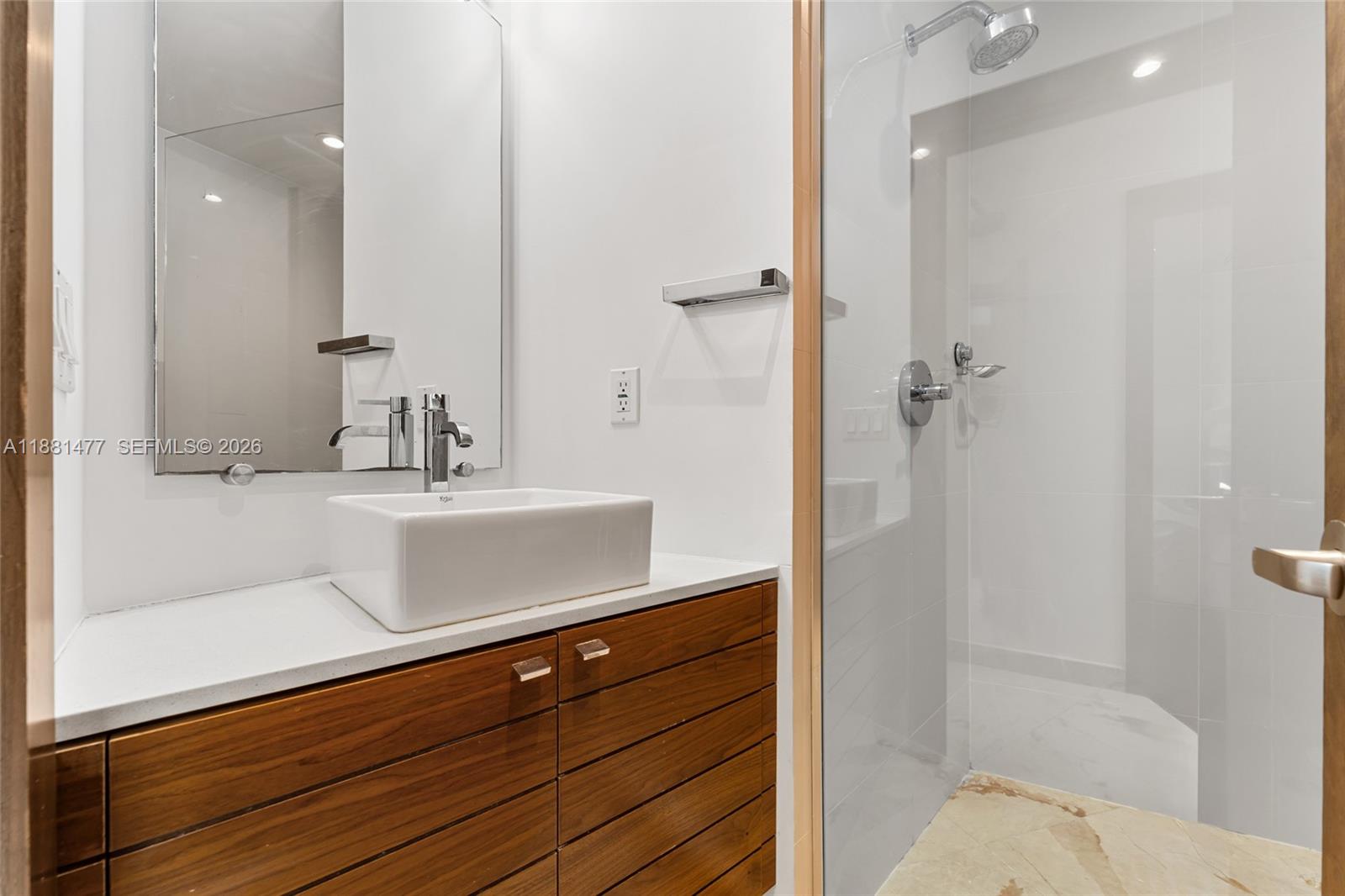 544 Fernwood Road, Unit 544 Key Biscayne, FL 33149 - Photo 28 of 35 a bathroom with a sink and a mirror