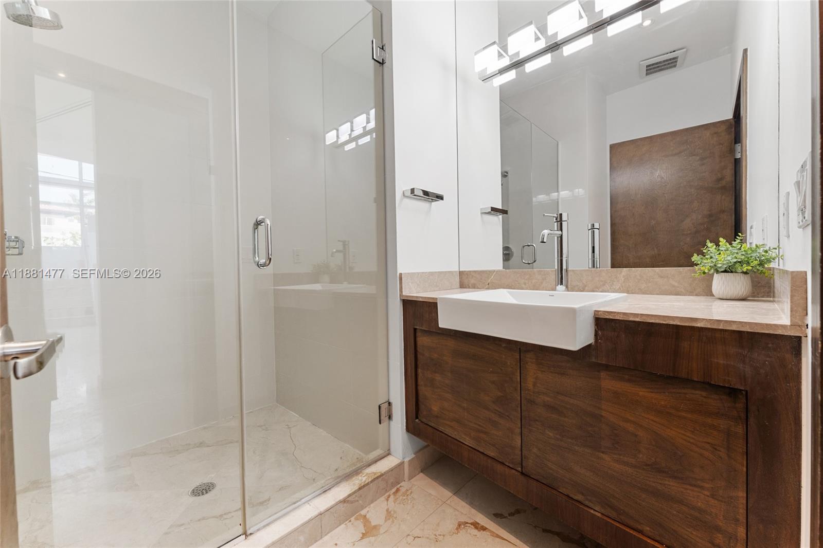 544 Fernwood Road, Unit 544 Key Biscayne, FL 33149 - Photo 29 of 35 a bathroom with a sink shower and a mirror
