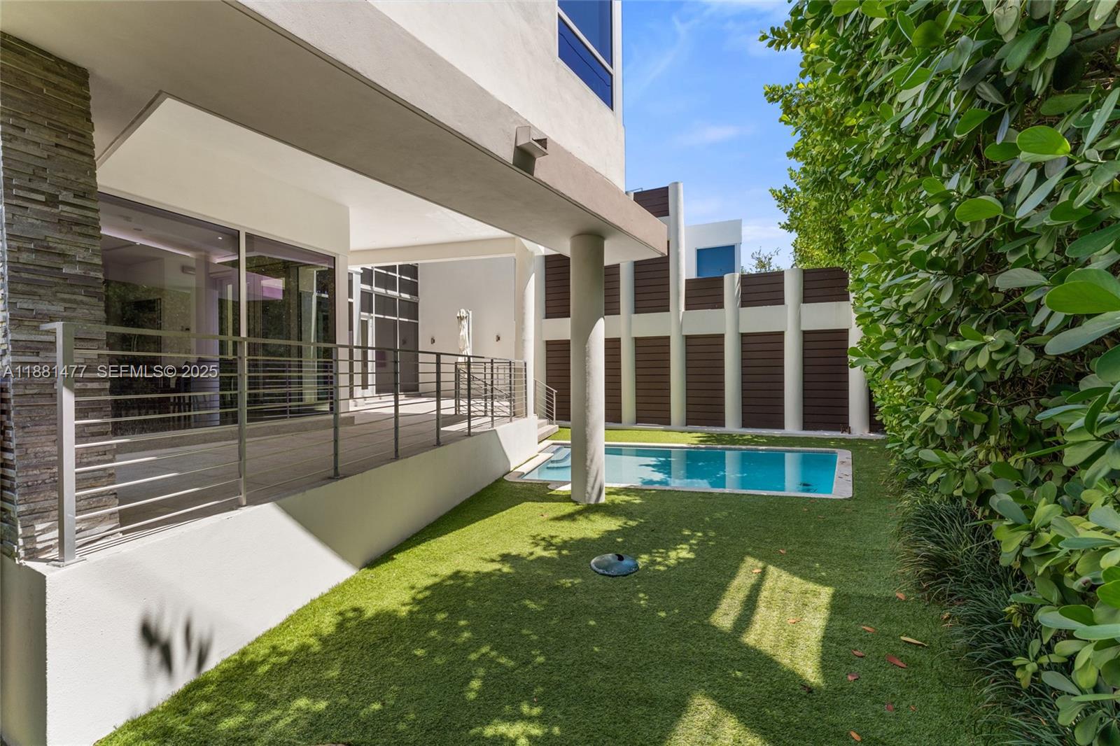 544 Fernwood Road, Unit 544 Key Biscayne, FL 33149 - Photo 3 of 42 a view of an apartment with a floor to ceiling window and brick wall