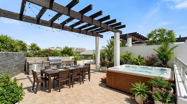 a view of a patio with table and chairs potted plants with wooden floor