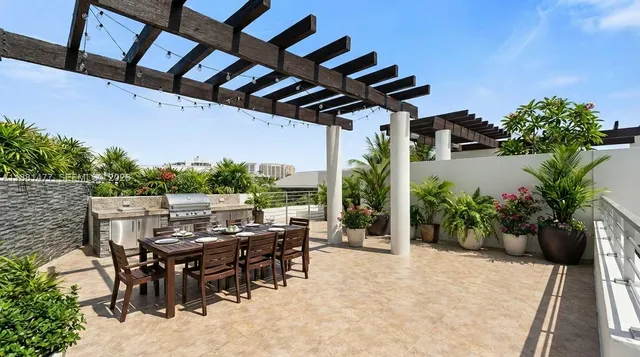 a view of a patio with table and chairs potted plants with wooden floor