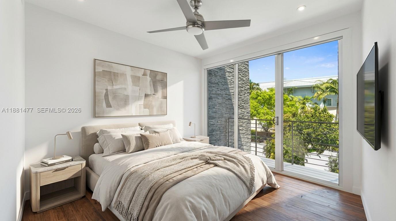 544 Fernwood Road, Unit 544 Key Biscayne, FL 33149 - Photo 7 of 35 a bedroom with bed and wooden floor