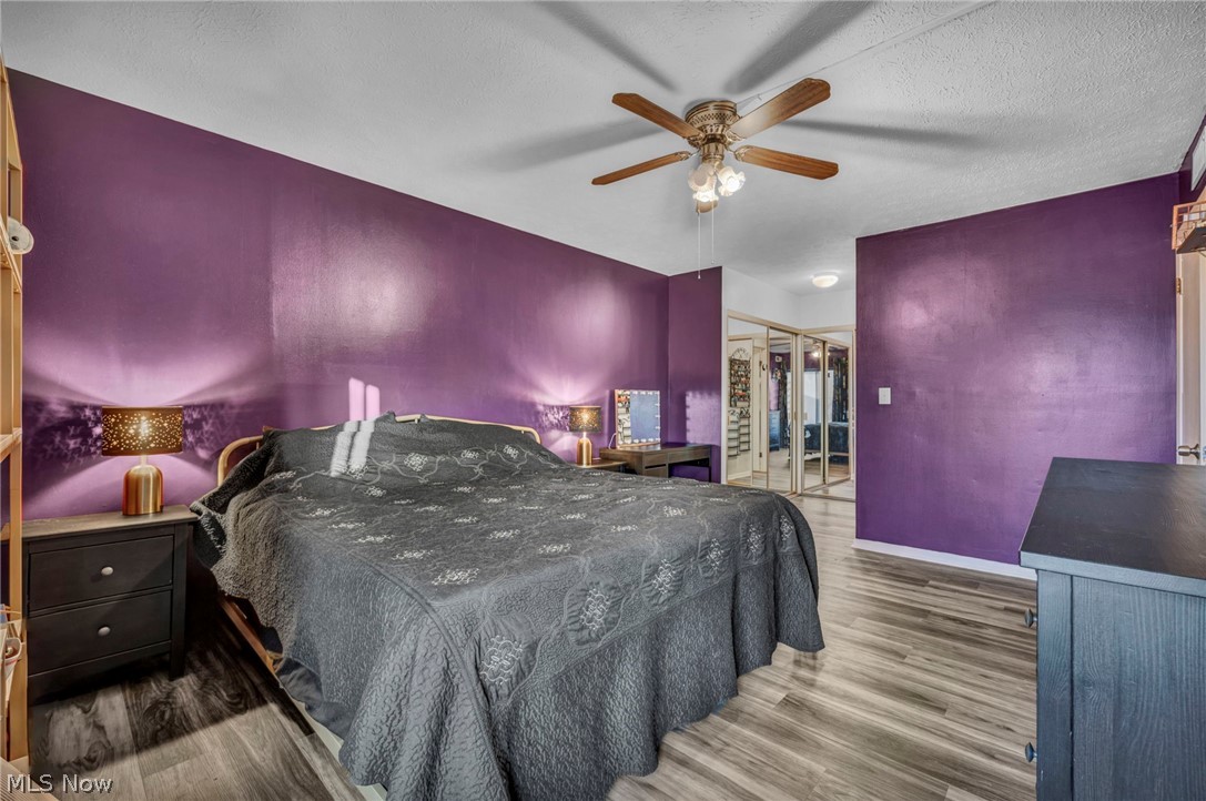 22952 Mastick Road, Unit 203 Cleveland, OH 44126 - Photo 16 of 35 Bedroom with a closet, ceiling fan, dark hardwood / wood-style flooring, and a textured ceiling