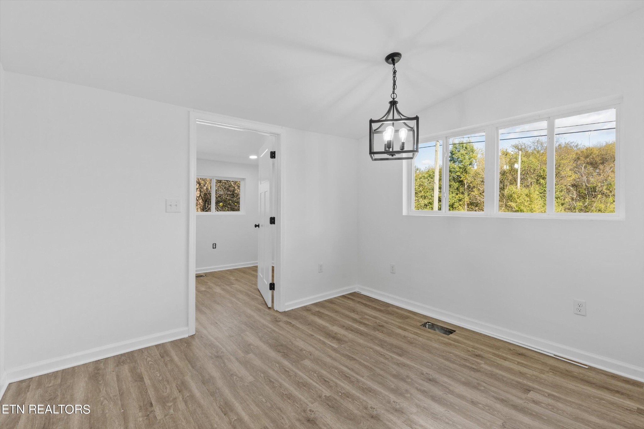 2399 Sweetwater Vonore Road Sweetwater, TN 37874 - Photo 12 of 26 an empty room with wooden floor and windows