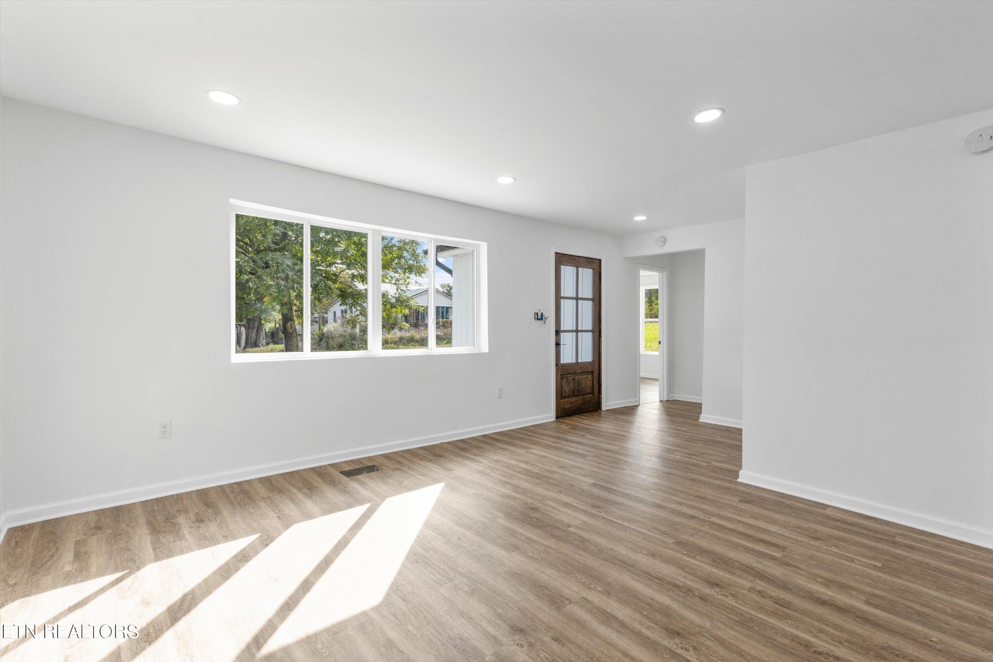 2399 Sweetwater Vonore Road Sweetwater, TN 37874 - Photo 8 of 26 an empty room with wooden floor and windows